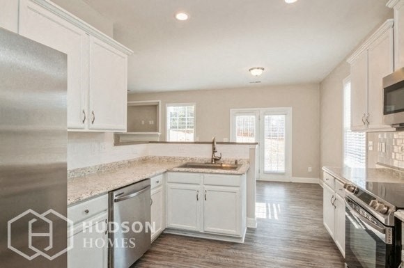 a large kitchen with white cabinets and a sink