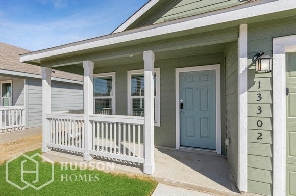 a front porch of a house with a blue door
