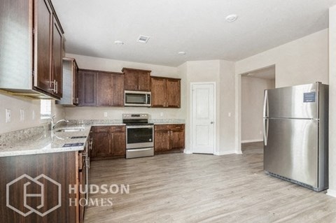 a kitchen with wooden cabinets and stainless steel appliances
