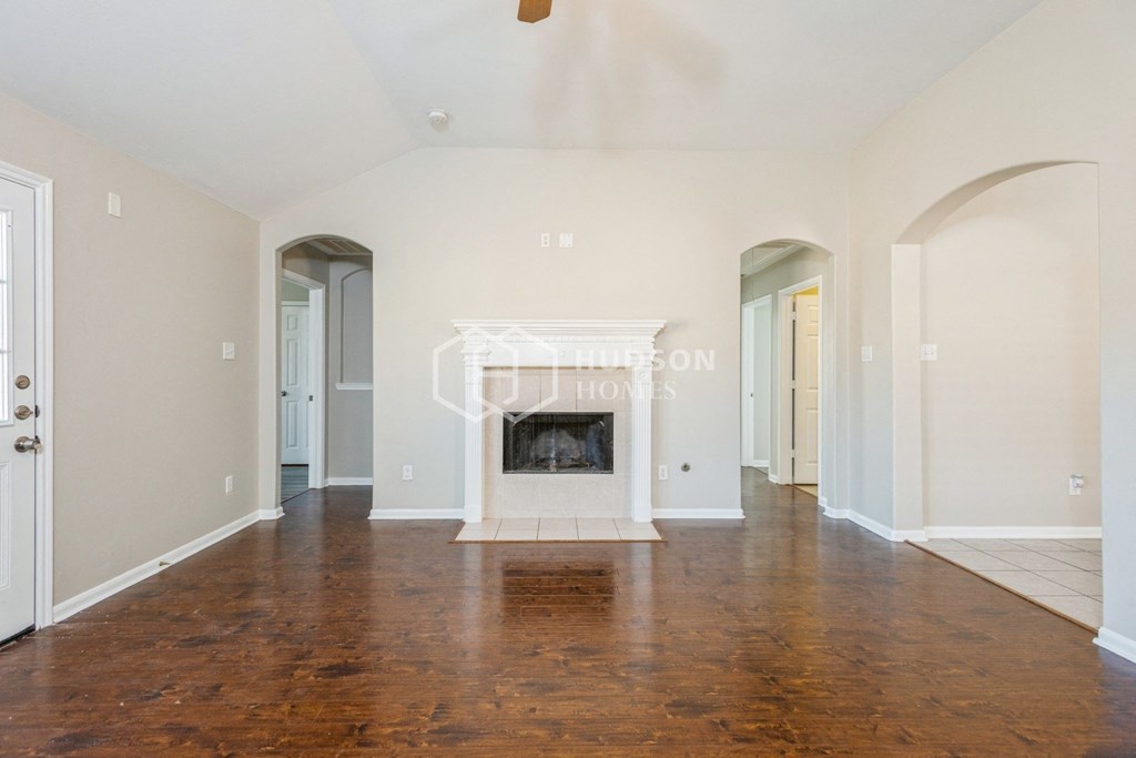 a living room with a fireplace and a wooden floor
