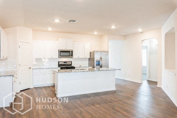a large kitchen with white cabinets and a white counter top