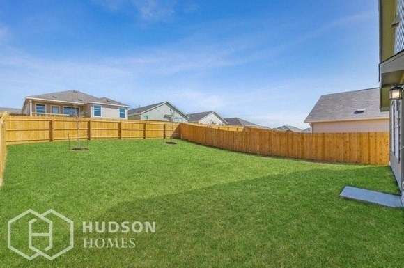 a fenced in backyard with a wooden fence