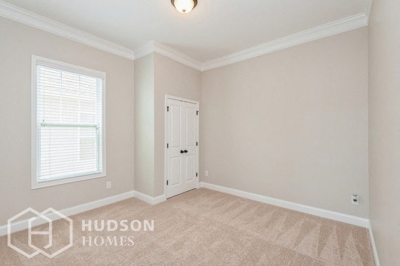 an empty room with a white door and a window