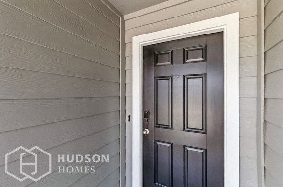 a black door on the side of a house