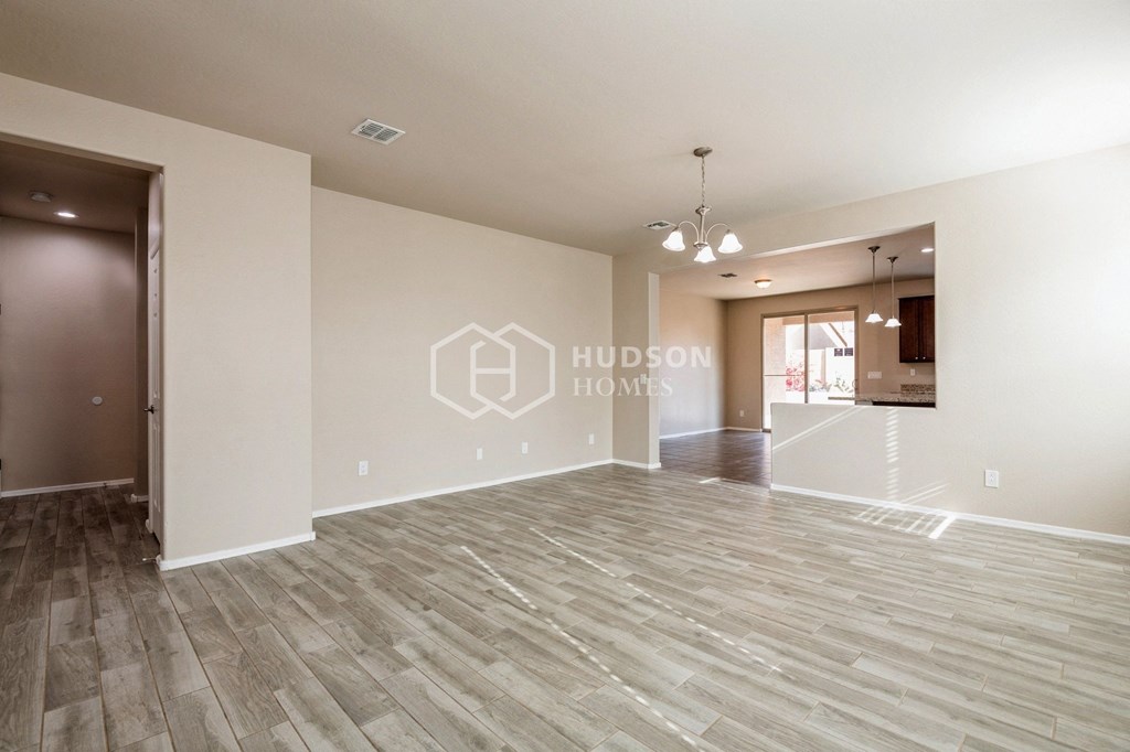 a white and gray living room with a hard wood floor