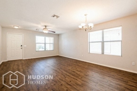 an empty living room with white walls and wood floors