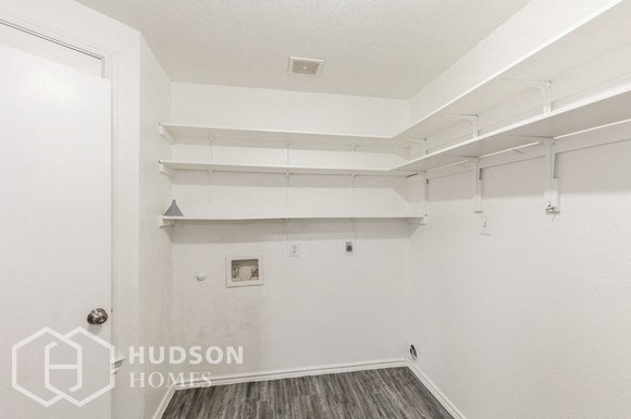 an empty room with white walls and white shelves on the wall