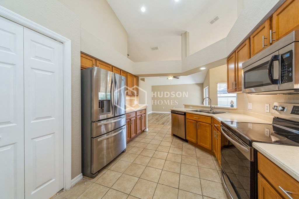 a kitchen with stainless steel appliances and wooden cabinets