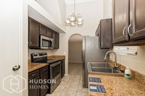 a kitchen with a sink and a refrigerator