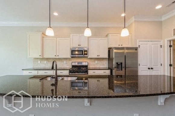 a large kitchen with white cabinets and a counter top