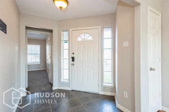 the entrance to a home with a white door
