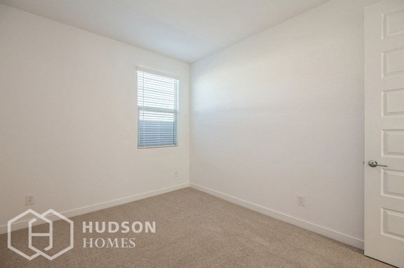 a bedroom with white walls and a white door