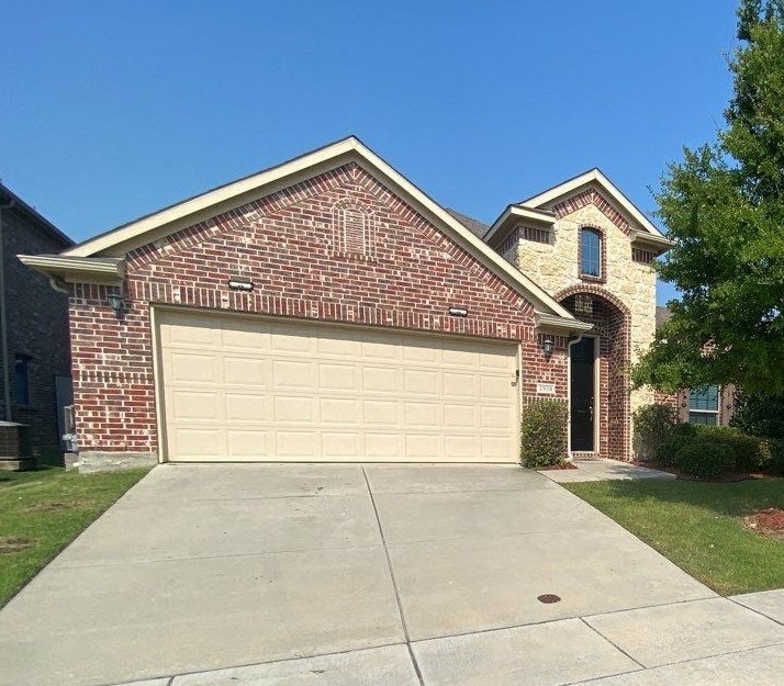 a garage door on the side of a brick house