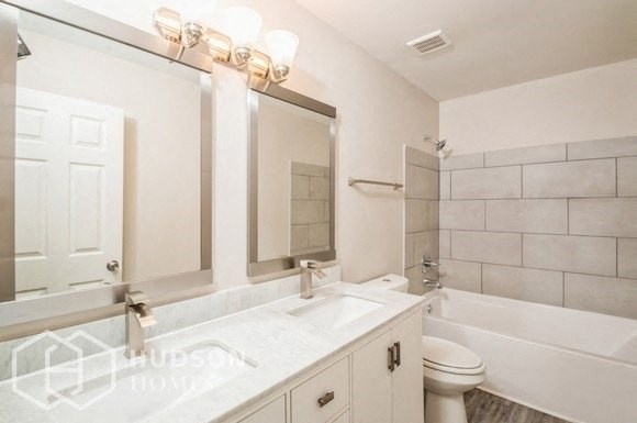 a white bathroom with a sink and a toilet