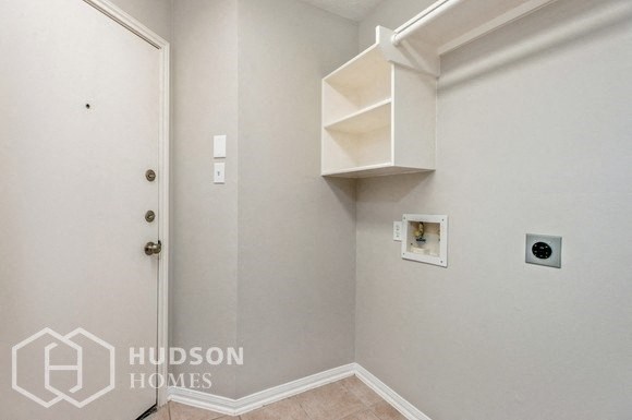 a white room with a white door and a shelf on the wall