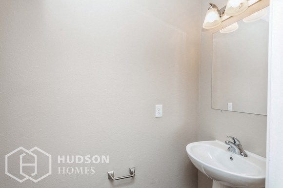 a white bathroom with a sink and a mirror