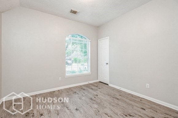 a white room with a window and a white door