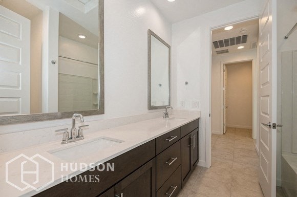 a bathroom with a sink and a mirror and a closet