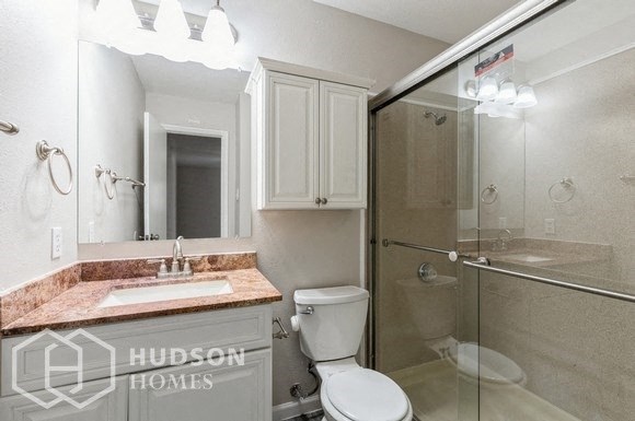 a bathroom with a sink toilet and a shower