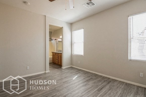 an empty room with a bathroom and a window