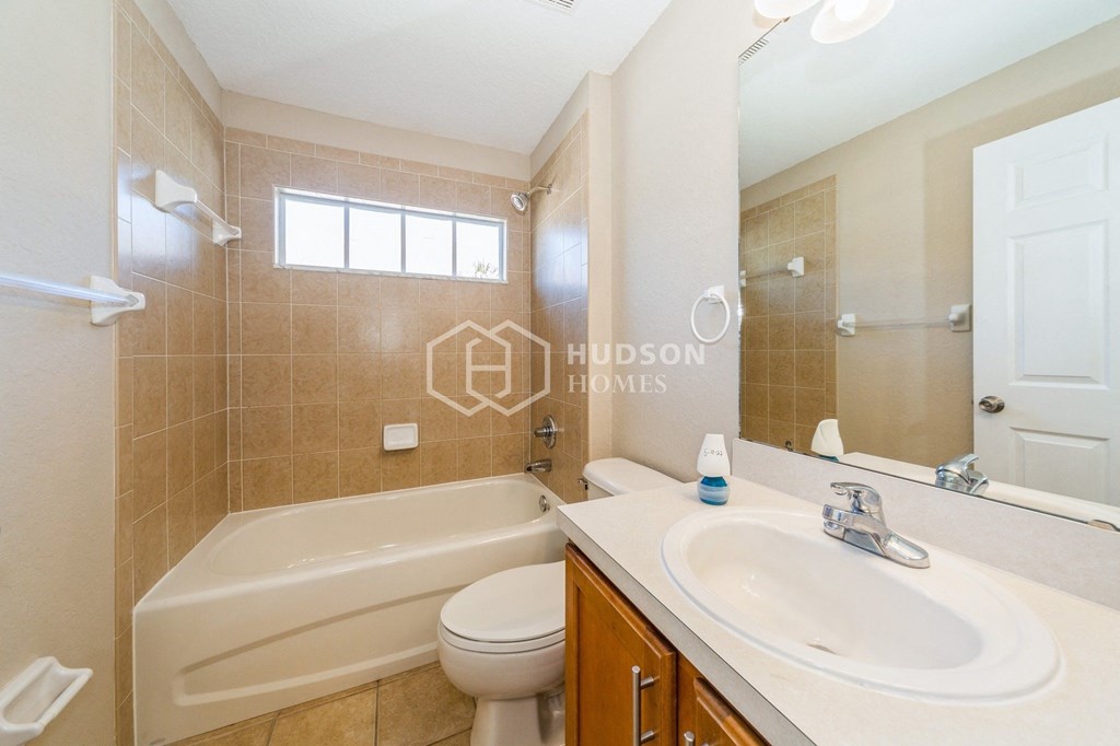 a bathroom with a sink toilet and a bath tub