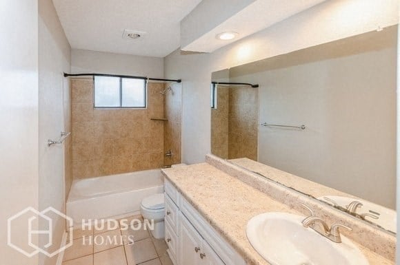 a bathroom with a sink and a shower and a toilet