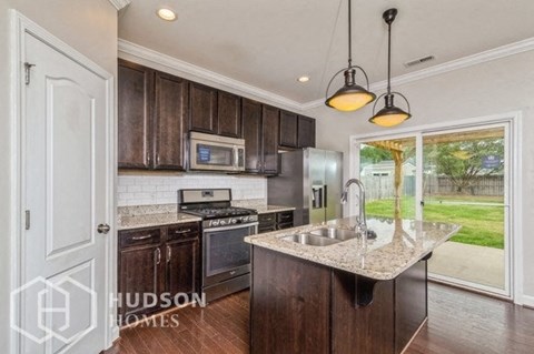 a kitchen with wooden cabinets and a sink and a window