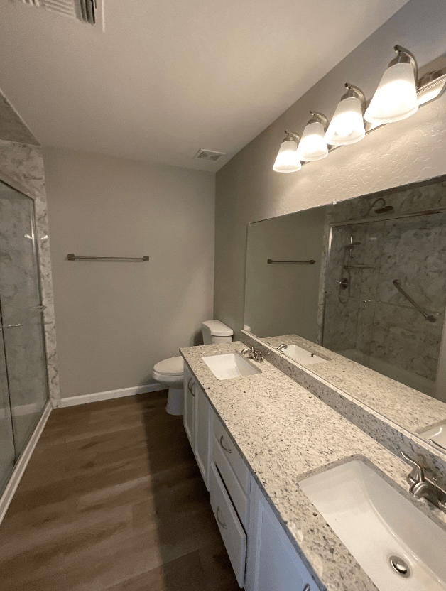 a bathroom with a sink and a shower and a toilet