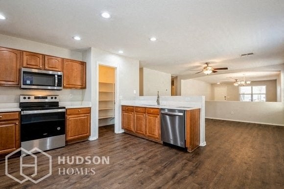 a large kitchen with a stove and a sink