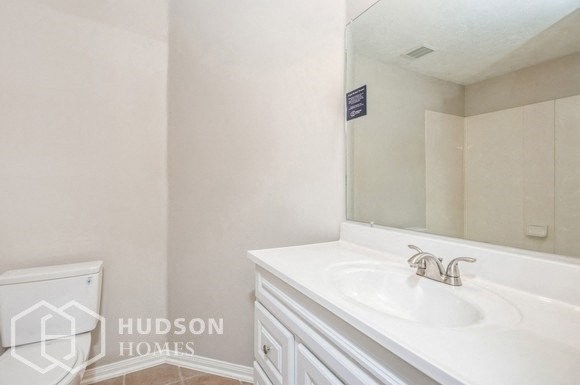 a white bathroom with a sink and a mirror