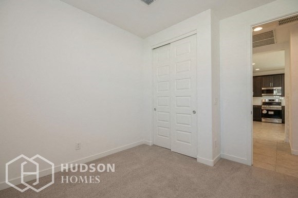a bedroom with a closet and a white door