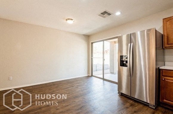 a empty kitchen with a stainless steel refrigerator