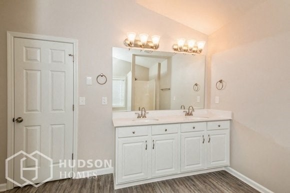 a white bathroom with two sinks and a mirror