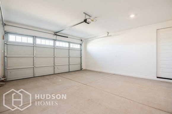 a garage with white walls and white garage doors