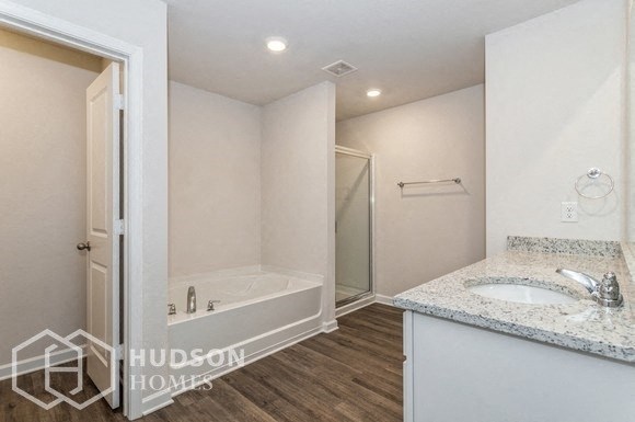 a bathroom with a sink and a bath tub and a mirror