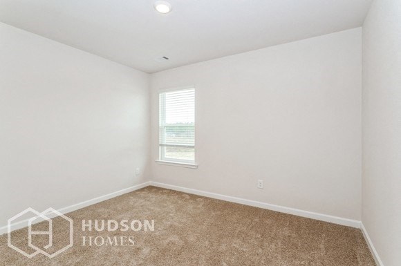 a room with a carpet and a window