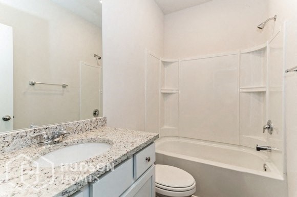 a bathroom with a sink toilet and a shower