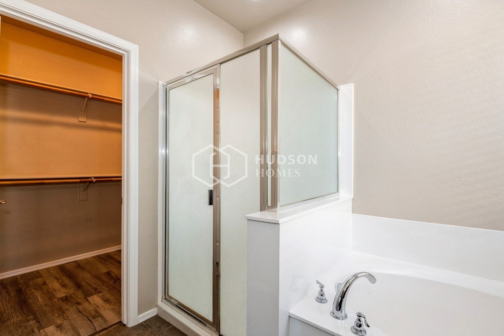 two closets and a shower in a bathroom