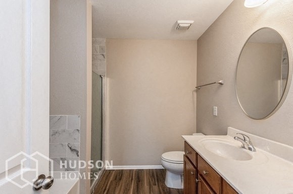 a bathroom with a sink and a toilet and a shower