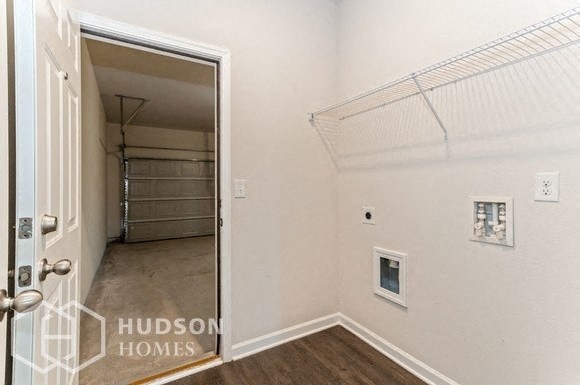 a white bedroom with a closet and a door to a garage