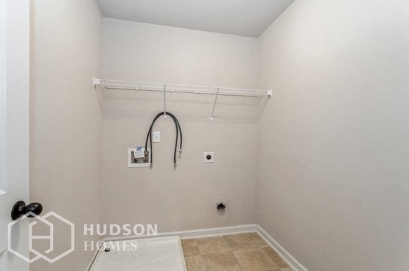 a small bathroom with a shower and a rack in the wall