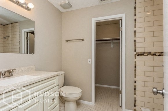 a bathroom with a toilet and a sink and a shower