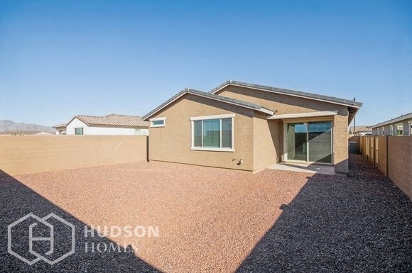 a house with a gravel driveway and a roof