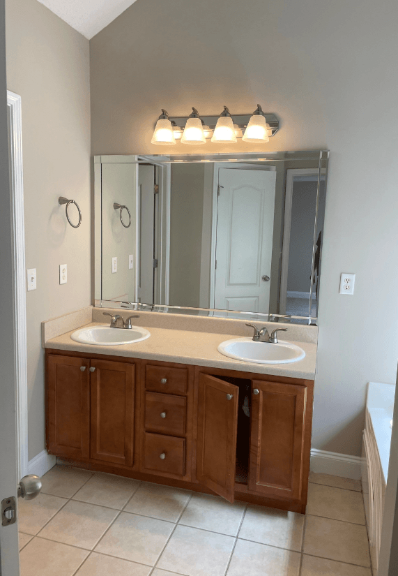 a bathroom with two sinks and a large mirror