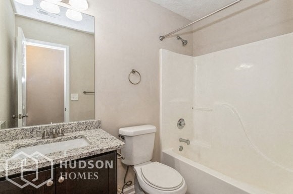 a bathroom with a sink toilet and a shower