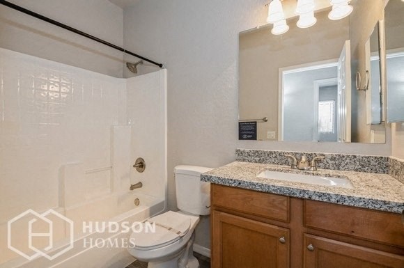 a bathroom with a sink and a toilet and a shower