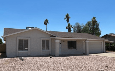 a white house with palm trees in the background
