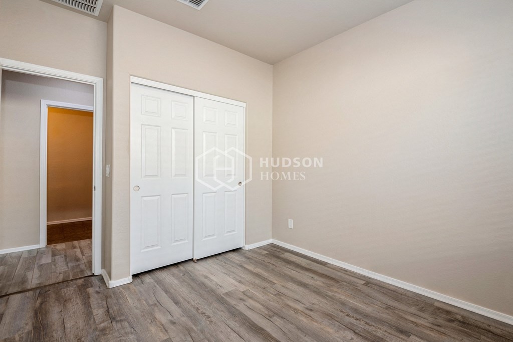 a bedroom with a closet and a white door