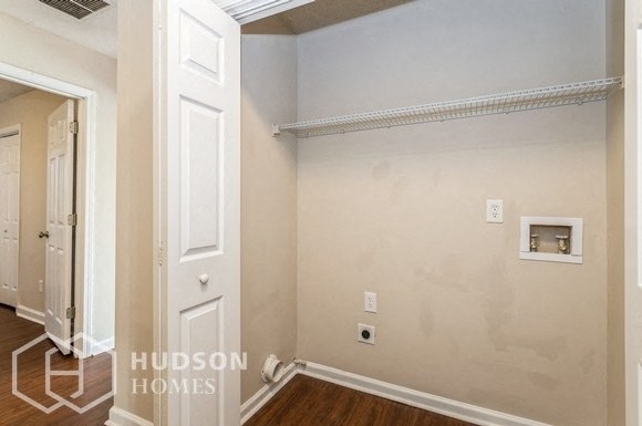 a empty room with a door and a hallway with a white door