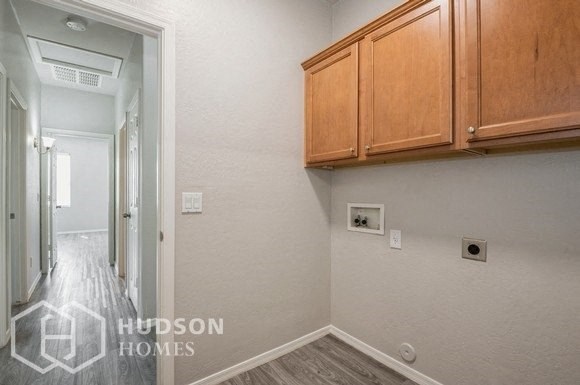 a white room with wooden cabinets and a hallway